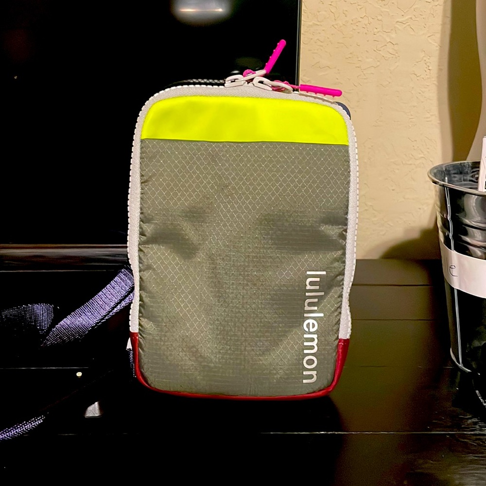 Lululemon crossbody with front phone pocket. Neon yellow, gray, navy